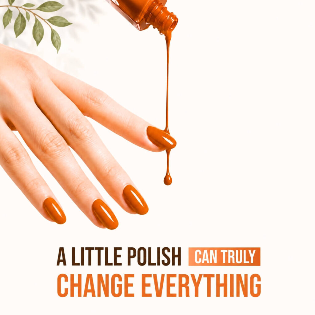 Hand with glossy orange nails beneath dripping orange nail polish